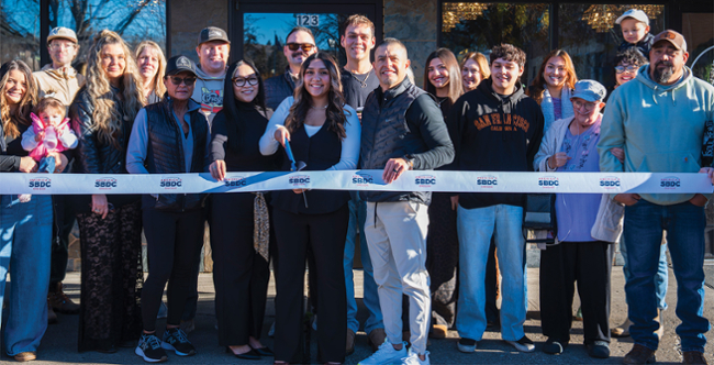 Friends and family help Ana Mendez, center, cut the ribbon to celebrate her ownership and opening of Soul Beauty Salon at 121 N. Seventh St in downtown Klamath Falls on Nov. 21. 