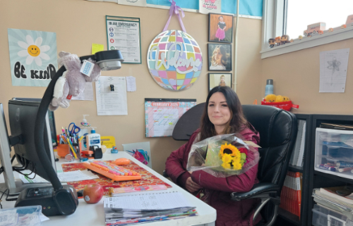 Stearns Elementary 4th Grade Teacher Chey Belcher poses with  a bouquet  of flowers given to her by a student.