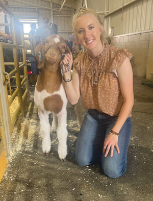 Emilee Lindquist with one of her prize goats.