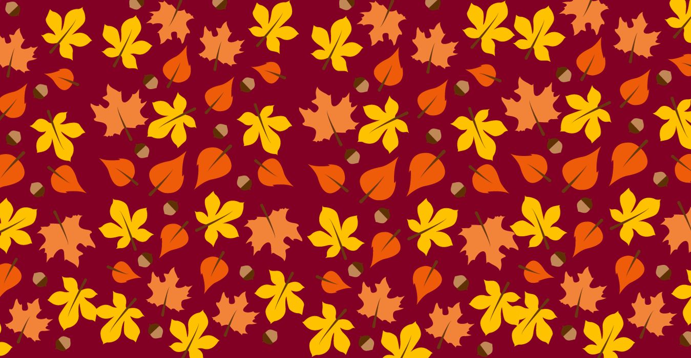 A banner of fall leaves against a burgundy background