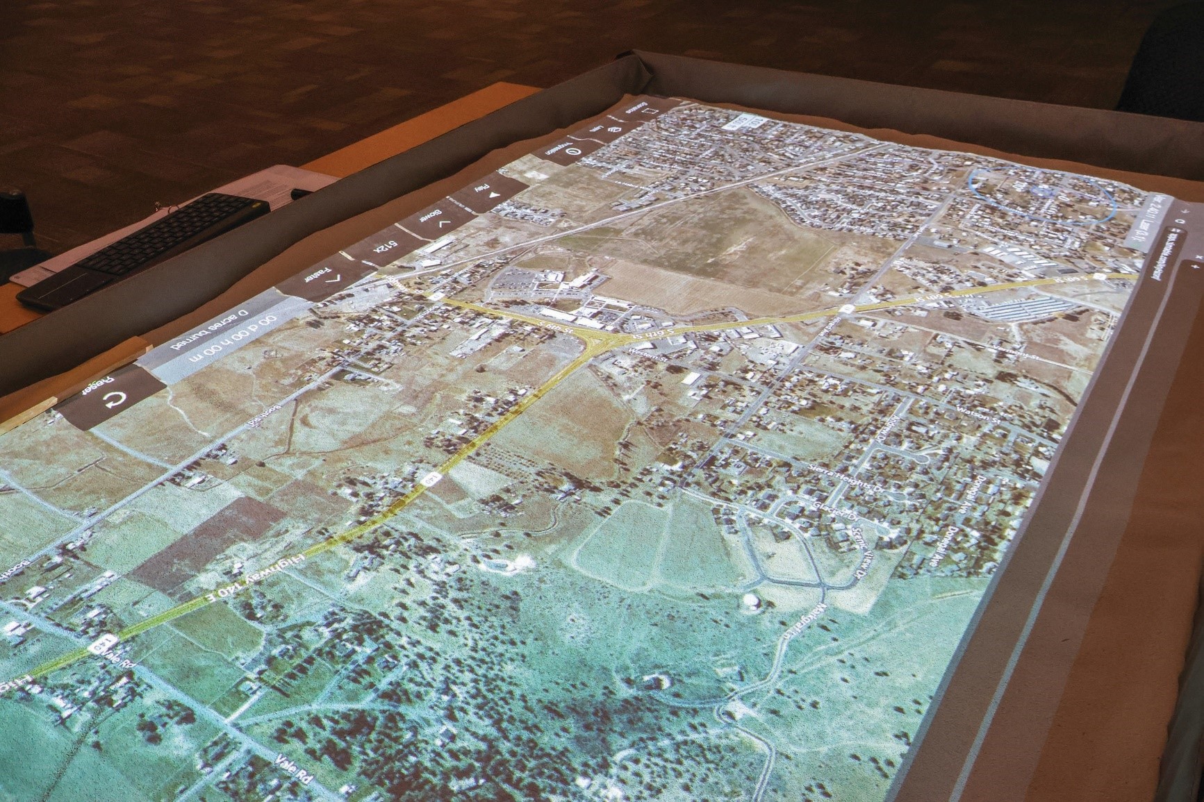 The simtable box is overlaid with computer mapping software to depict actual, potential wildfire scenarios, such as this view of Klamath Falls