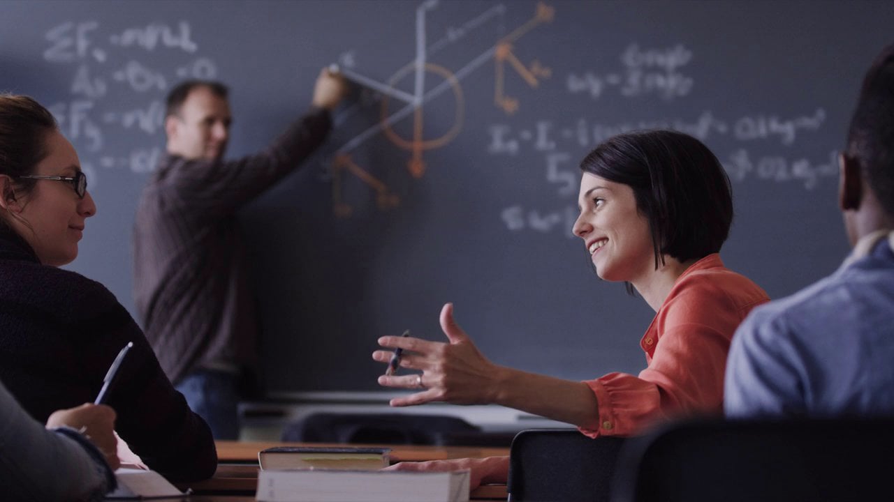 Class in a classroom discussing