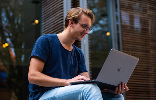 Male student looking at a laptop