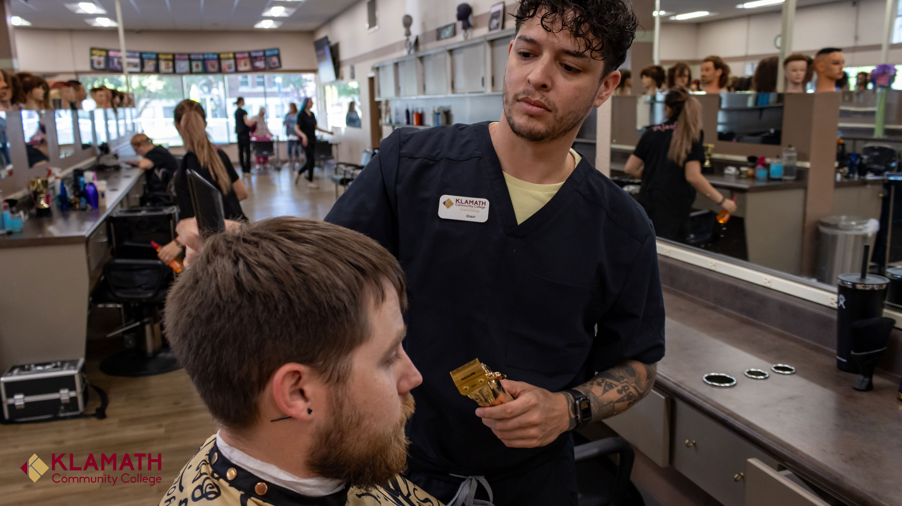 cosmetology student cutting a male persons hair